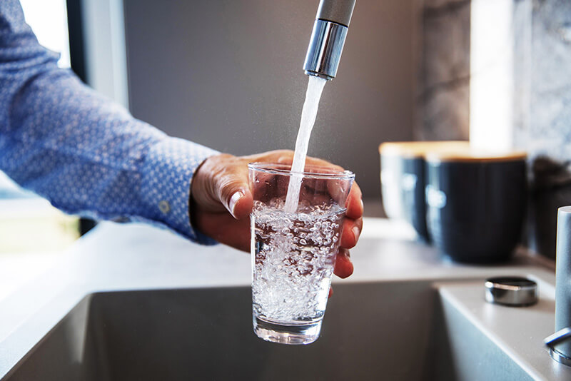 A man filling a glass with water