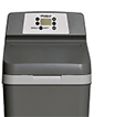 A gray water softener unit displayed indoors, featuring a control panel with buttons and a small screen, set against a plain white background.
